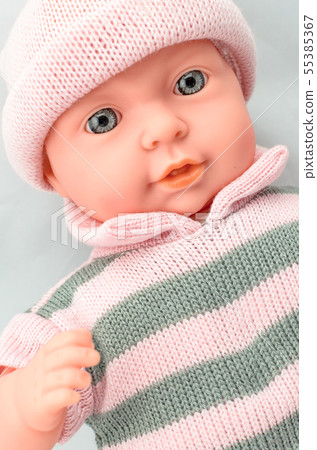 Cute baby doll for girl in knitted dress close up Cute baby doll for girl in knitted dress close up 55385367