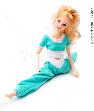 A pretty doll sitting in the pose of twine stretched legs to the side A pretty doll sitting in the pose of twine stretched legs to the side 55385422