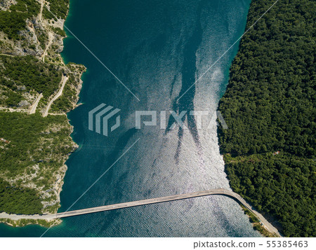 Aerial footage a car driving over a bridge on Piva Lake 55385463