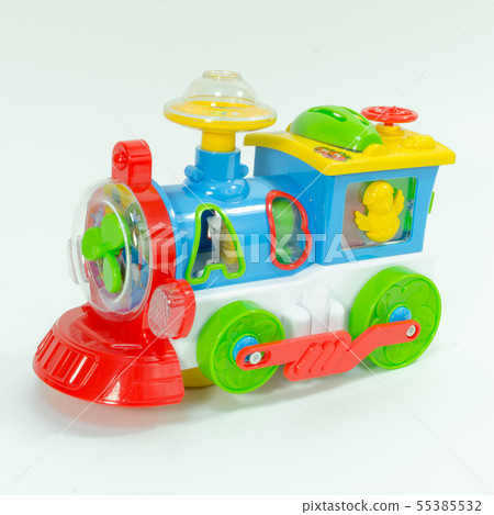 Plastic toy train isolated on white background. Children's toy plastic locomotive with abs letters. Plastic toy train isolated on white background. Children's toy plastic locomotive with abs letters. 55385532