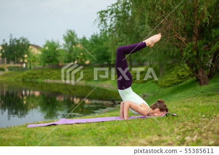 Slender young brunette yogi performs challenging 55385611