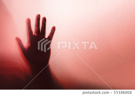 Shadow of the ghost hand behind frosted glass for 55386008