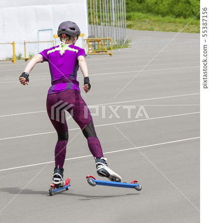 girl sportswoman rides on the roller skis on the girl sportswoman rides on the roller skis on the 55387156