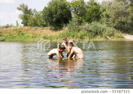 Jumping in the water. Kids have fun and  55387331