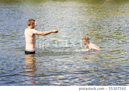 two friends are swimming in the river. two friends are swimming in the river. 55387592