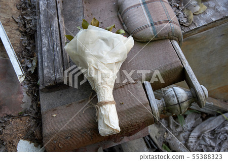 Bunch of flowers is lying on old broken furniture 55388323