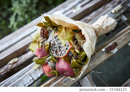 Bunch of rotten fruit and wilted flowers 55388325
