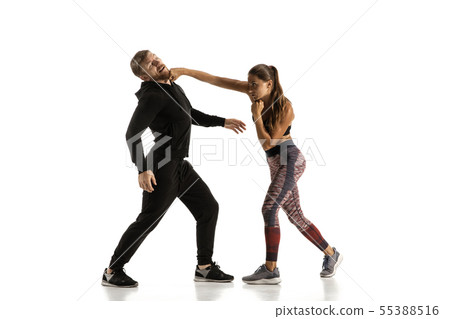 Man and woman fighting in studio, women's self-defense concept Man and woman fighting in studio, women's self-defense concept 55388516