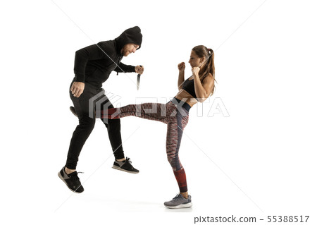 Man and woman fighting in studio, women's self-defense concept Man and woman fighting in studio, women's self-defense concept 55388517