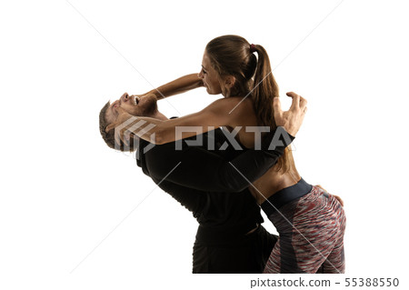 Man and woman fighting in studio, women's self-defense concept 55388550