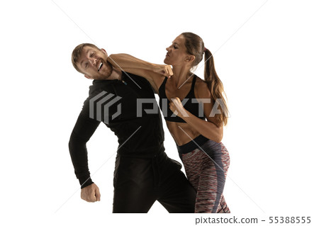 Man and woman fighting in studio, women's self-defense concept 55388555