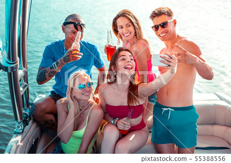 Pretty girl taking a selfie with her friends Pretty girl taking a selfie with her friends 55388556