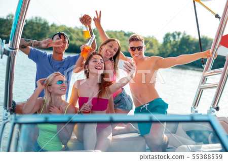 Group of friends taking selfies on a yacht 55388559
