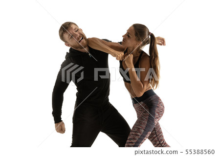 Man and woman fighting in studio, women's self-defense concept 55388560