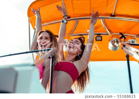 Young female friends enjoying life to the full Young female friends enjoying life to the full 55388615