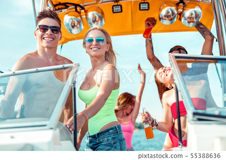 Smiling young couple standing at the steering wheel Smiling young couple standing at the steering wheel 55388636