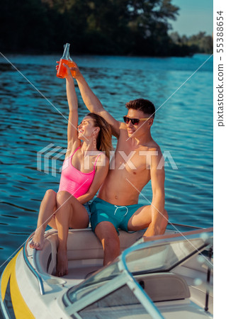 Smiling woman with closed eyes and her boyfriend Smiling woman with closed eyes and her boyfriend 55388654