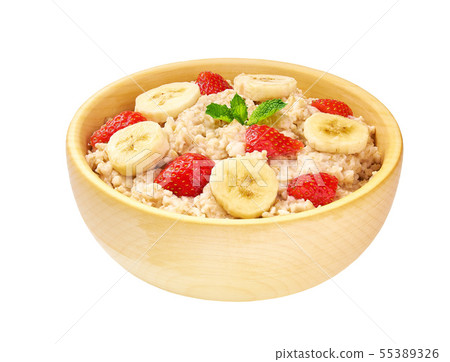 Wooden bowl of oatmeal porridge with banana and Wooden bowl of oatmeal porridge with banana and 55389326