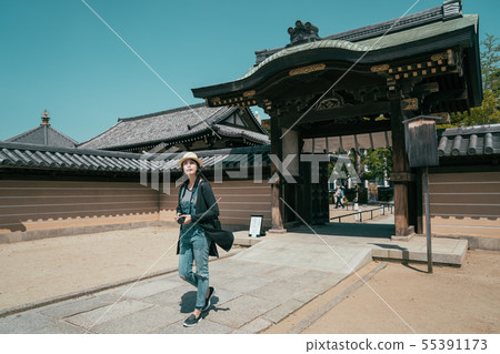 temple entrance wooden gate with tourist walking 55391173