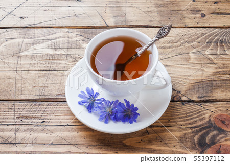 Cup with chicory drink and blue chicory flowers Cup with chicory drink and blue chicory flowers 55397112