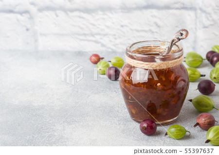 Gooseberry jam in a jar with fresh gooseberry 55397637