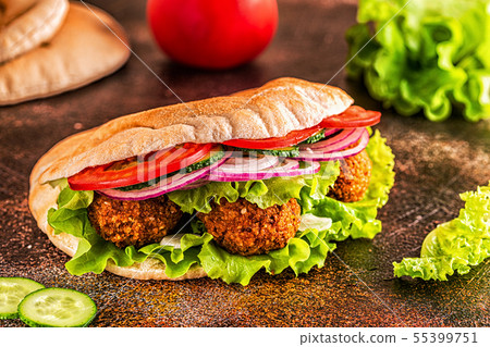 Falafel and fresh vegetables in pita bread. 55399751