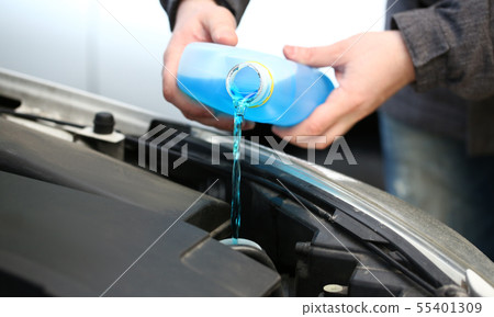Male serviceman hands pouring blue washer 55401309