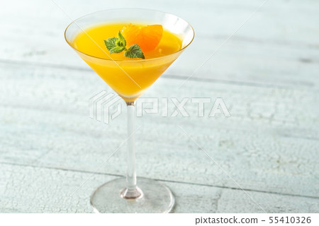 Cocktail glass with orange jelly dessert Cocktail glass with orange jelly dessert 55410326