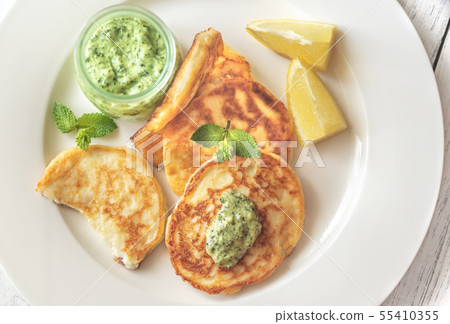 Portion of ricotta fritters with mint sauce Portion of ricotta fritters with mint sauce 55410355