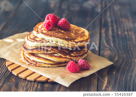 Stack of pancakes with fresh raspberries Stack of pancakes with fresh raspberries 55410387