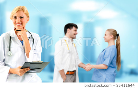 Doctor working in hospital with other doctors. 55411644