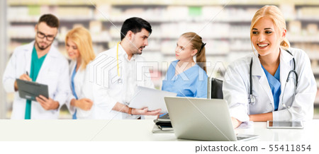 Doctor working in hospital with other doctors. Doctor working in hospital with other doctors. 55411854