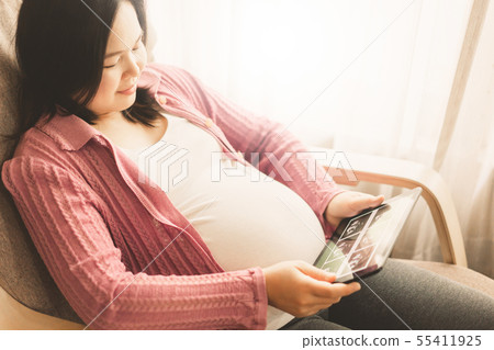 Happy pregnant woman and expecting baby at home. 55411925