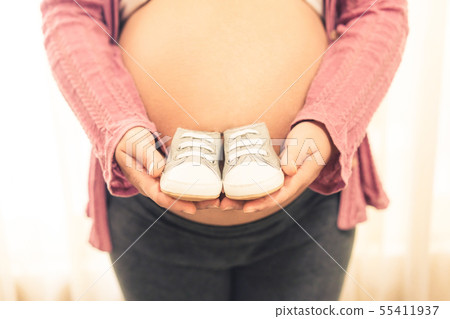 Happy pregnant woman and expecting baby at home. Happy pregnant woman and expecting baby at home. 55411937