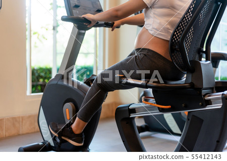 Active pregnant woman exercise in fitness center. Active pregnant woman exercise in fitness center. 55412143