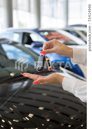 Dealer woman holding keys to a new car. 55414946