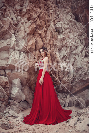 Girl in a red dress with a long skirt Girl in a red dress with a long skirt 55415312