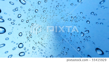 Rain Drops On Blue Glass Window Background Stock Photo