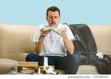 Young man suffering from hausehold dust or seasonal allergy. Young man suffering from hausehold dust or seasonal allergy. 55416787