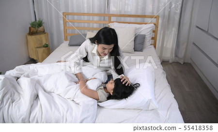Family concept. Mom is lulling her daughter to Family concept. Mom is lulling her daughter to 55418358