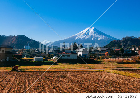 Snow covered Mount Fuji and local town along train 55418658