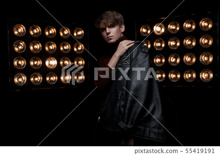 Serious young man with a fashionable hairstyle Serious young man with a fashionable hairstyle 55419191