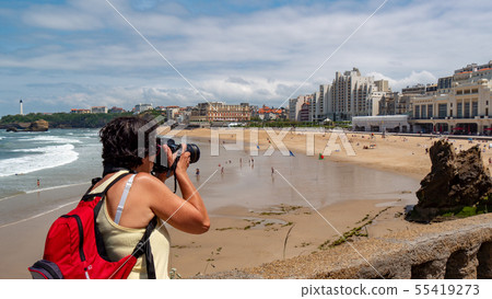 female photographer taking a photograph of the 55419273