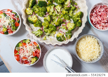 preparation of french  quiche with tomatoes and 55419274