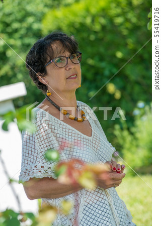 portrait of a beautiful senior woman in the garden portrait of a beautiful senior woman in the garden 55419716