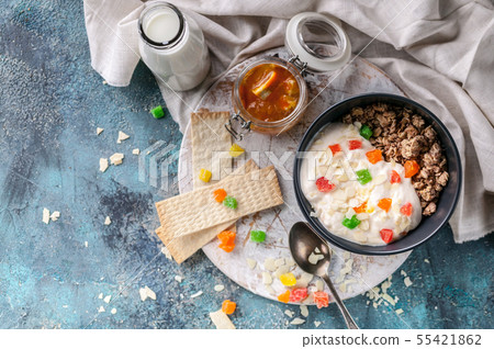 Muesli or Granola with candied fruit in a bowl Muesli or Granola with candied fruit in a bowl 55421862