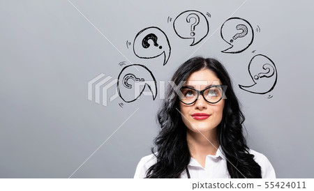 Question marks with speech bubbles with young businesswoman 55424011