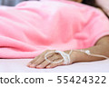 Close up of saline solution on left hand of women. 55424322