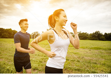 happy young Couple jogging and running on the 55425541