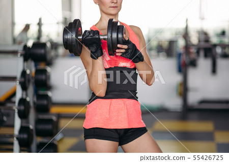 Crop of sporty woman making exercise with 55426725